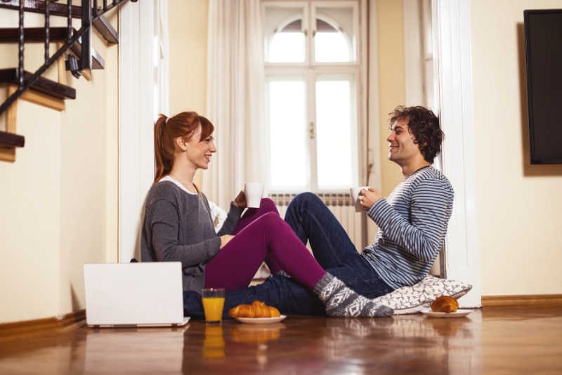 How to determine heat pump efficiency. Lovely young couple at home, having breakfast together.